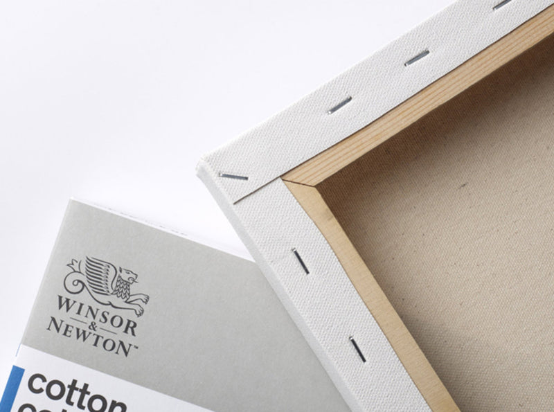 Close up of the stapled back of a Winsor & Newton Cotton Canvas that measures 10 by 12 inches and comes in a box of 6