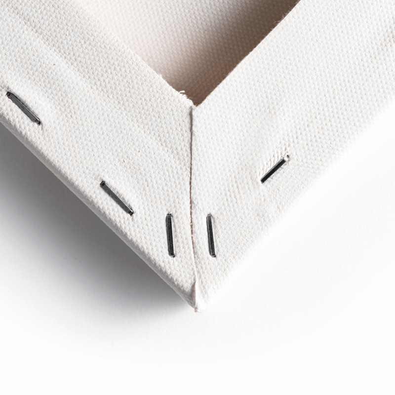 Close up of the corner of the back of the canvas, showing the staples and wooden frame of a Loxley Gold Standard Canvas that measures 14 by 10 inches and comes in a box of 10.